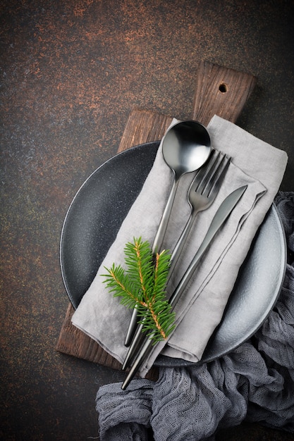 Elegant steel cutlery with napkin on a plate