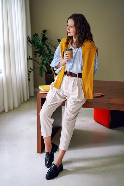 elegant stylish woman posing in oficce, young blogger buinesswoman indoor.
