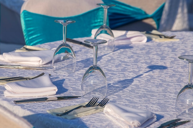 Elegant table setting with fork, knife, wine glass and napkin in restaurant . Nice dining table set with arranged silverware and napkins for dinner, Turkey, close up