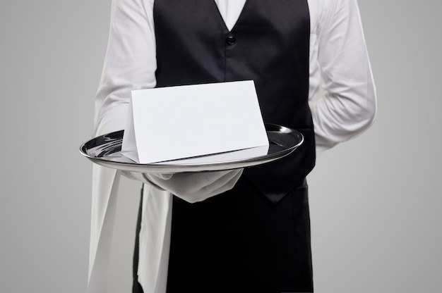 Elegant waiter with blank paper on tray