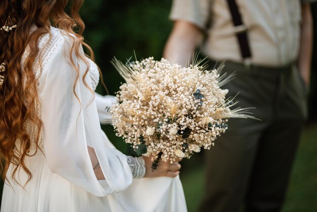 Elegant wedding bouquet of fresh natural flowers and greenery