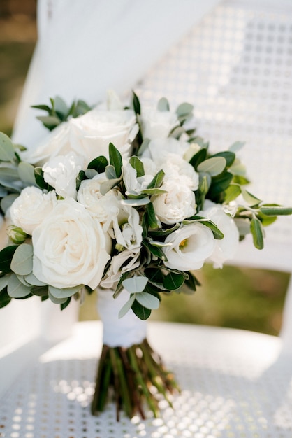 Elegant wedding bouquet of fresh natural flowers and greenery