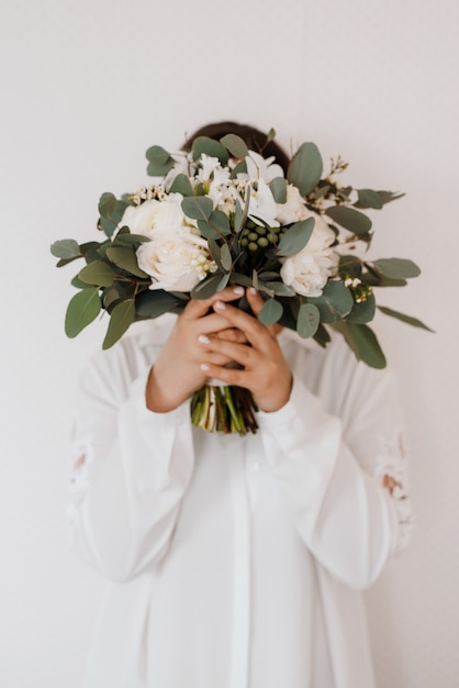 Elegant wedding bouquet of fresh natural flowers and greenery