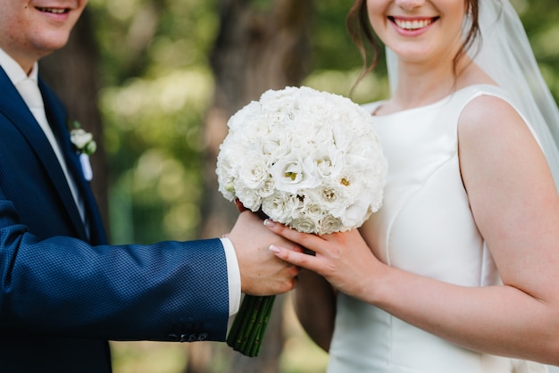 Elegant wedding bouquet of fresh natural flowers and greenery