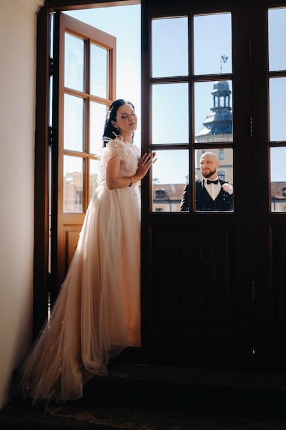 Elegant wedding couple on the balcony of an old castle in the city of Nesvizh.