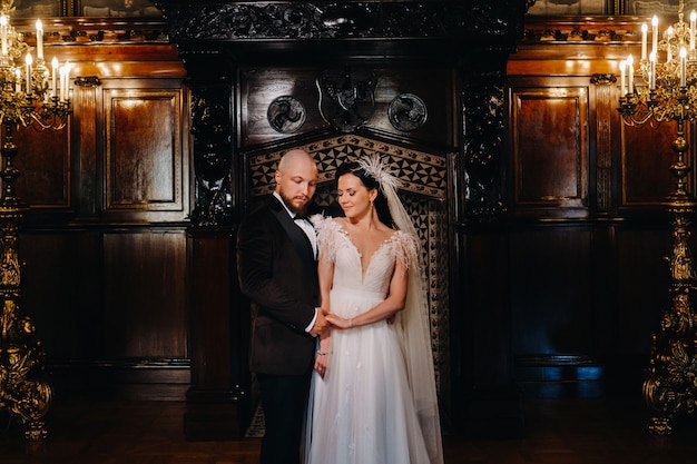 Elegant wedding couple in the interior of the old castle in the city of Nesvizh.