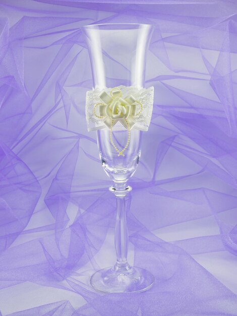 Elegant wedding wine glass on a purple background