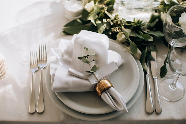 Elegant white dining table setting in the restaurant for the wedding dinner