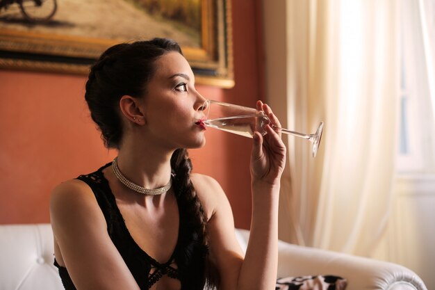 Elegant woman drinking champagne