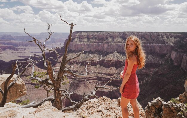 Elegant woman on grand canyon young woman enjoying scenic dramatic view of american national park tr