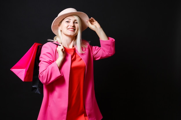 Elegant woman holding black shopping bags, black friday concept