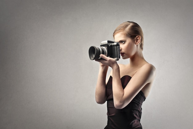 Elegant woman holding a camera