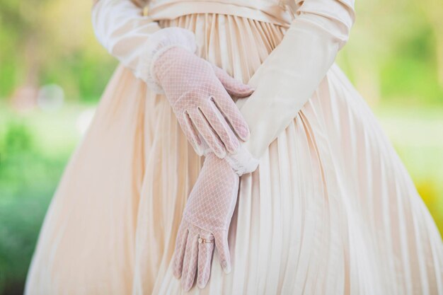 Elegant woman in an old dress and gloves