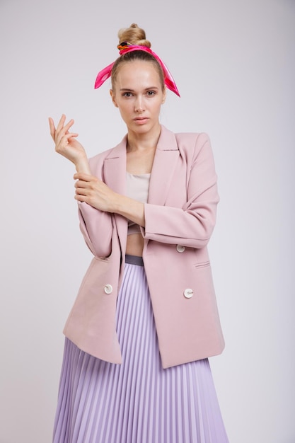 elegant woman in pretty pastel  pink jacket, lilac skirt on white background