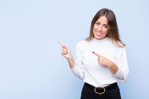 elegant woman smiling happily and pointing to side