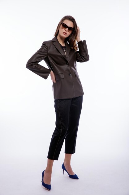 Elegant woman in suit leather dark olive khaki jacket trousers pants sunglasses on white background