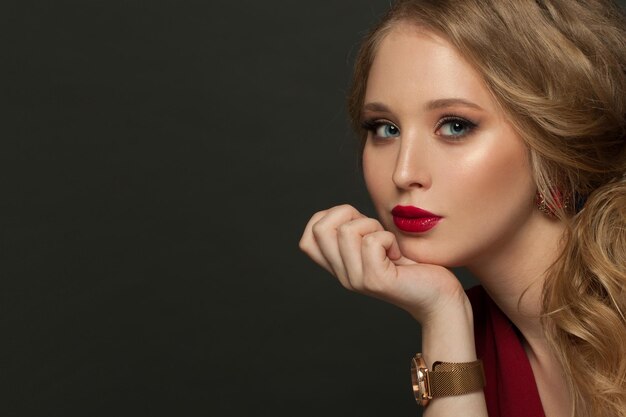 Elegant woman with golden hand watch portrait