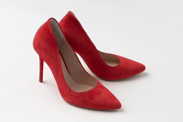 Elegant women's summer suede red stilettos A new pair of shoes on a white background