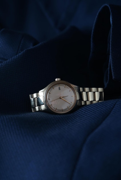 Elegant wrist watch closeup on blue background