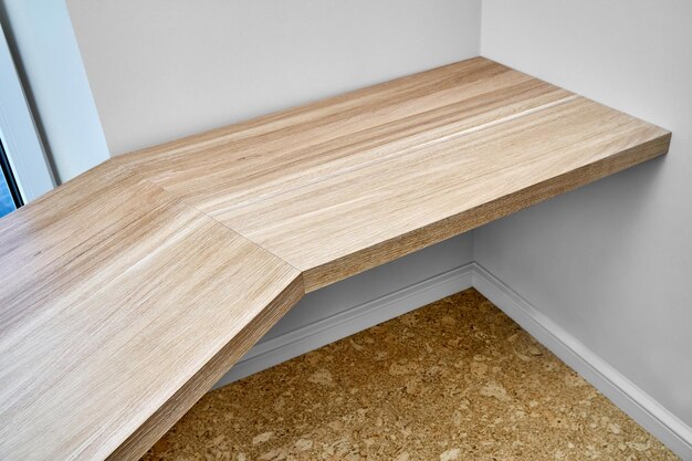 Elegant writing desk made with bleached solid oak timber mounted on white wall upper view