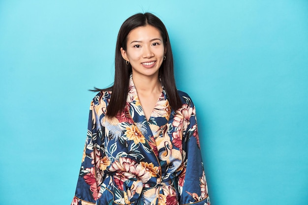 Elegant young Asian woman in kimono studio shot happy smiling and cheerful