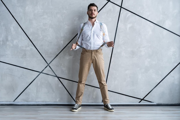 Elegant young handsome man. Good looking young man standing against grey background