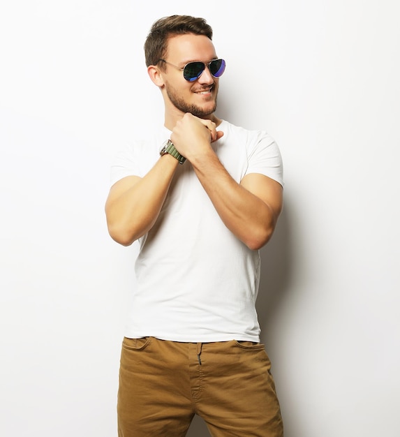 Elegant young handsome manin smart casual wear and sunglasses
