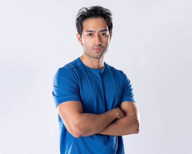 Elegant young man in blue shirt standing on white background