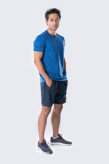 Elegant young man in blue shirt standing on white background