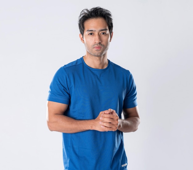 Elegant young man in blue shirt standing on white background