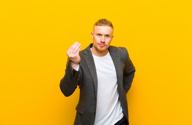 elegant young man showing money symbol