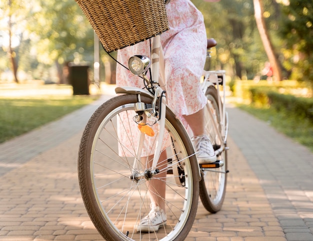 Elegant young woman riding bicycle