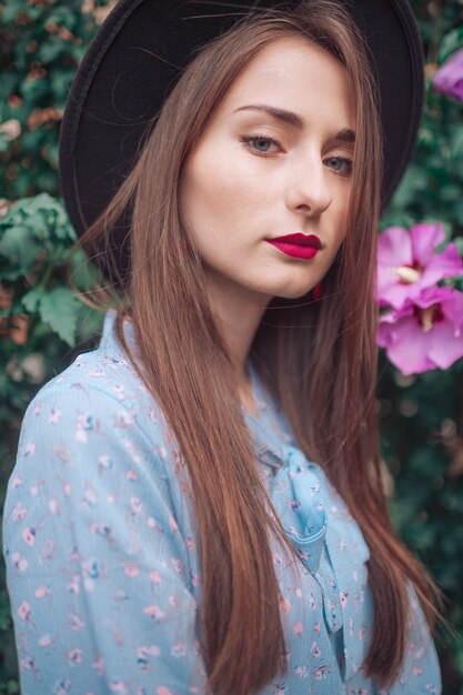 Elegant young woman with blooming flowers