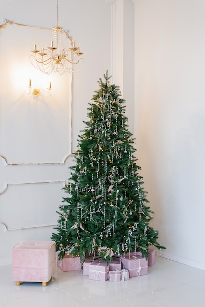 Elegante en mooie kerstboom in het interieur van een lichte woonkamer.