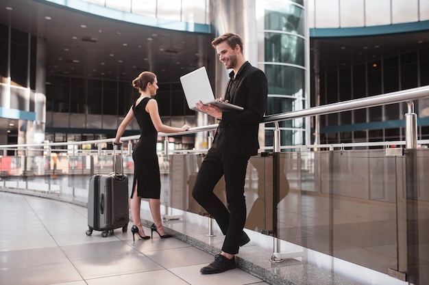 Elegante vrouw en man aan het werk op de luchthaven