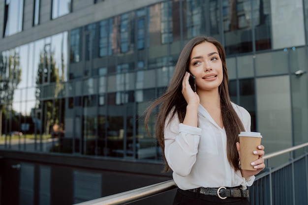 Elegantly dressed beautiful women working in a corporation a company walked outside