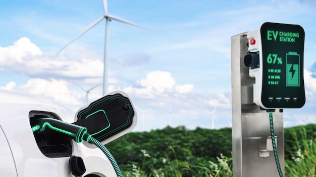 Elektrische auto oplaadt energie van laadstation in windturbineparkPeruse