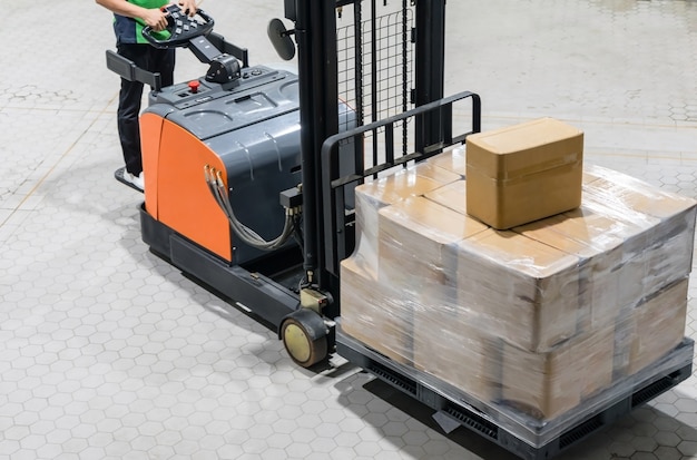 Foto elektrische vorkheftruck met dozen op pallet in magazijn