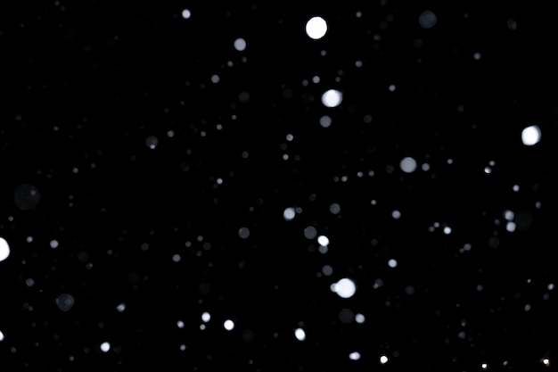 Element for winter design or overlay. Real snow over black background with a shallow depth of field.