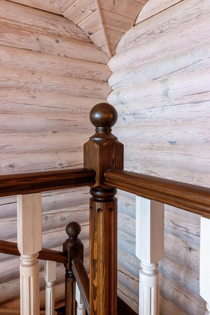 Element of a wooden interior staircase Wooden baluster closeup