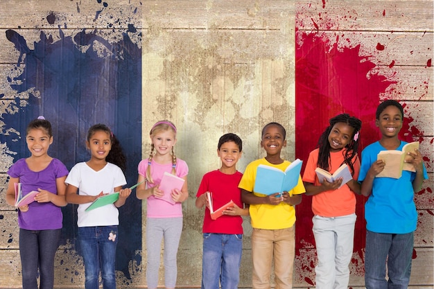 Photo elementary pupils reading books against france flag in grunge effect