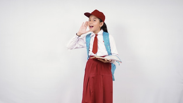 Elementary school little girl screaming to the side isolated on white background