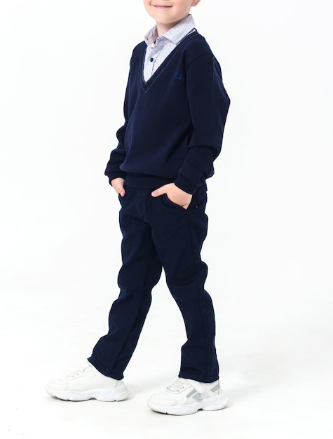 Elementary school student in a school uniform on a white background Vertical photo