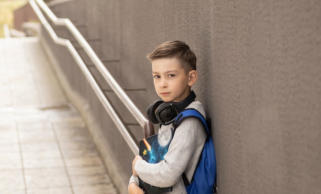 Elementary Student In Front Of His Home Smiling With Backpack