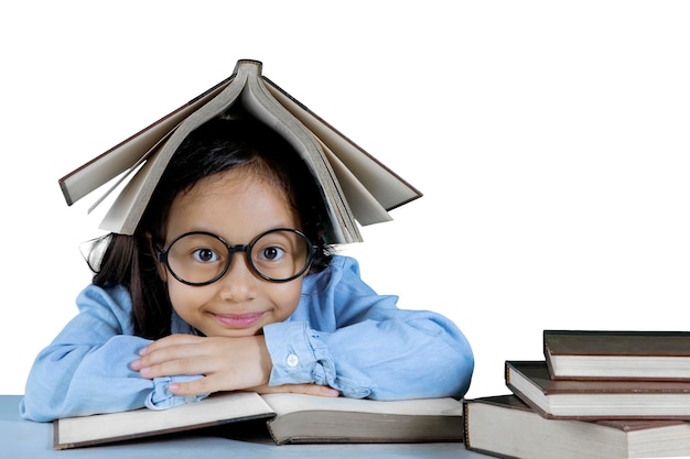 Elementary student with a book over her head