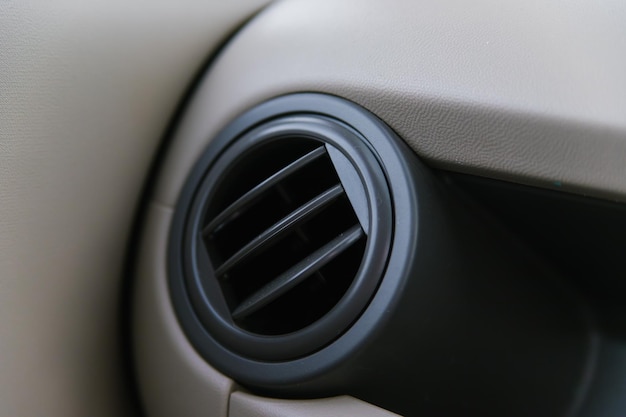 Elements of an automobile air conditioner Details of the front panel of the car with air diffusers Beige interior of the car