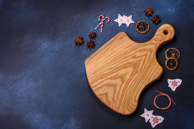 Elements of Christmas decorations sweets and gingerbread on a wooden cutting board