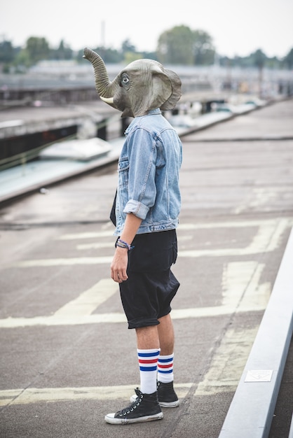 Photo elephant mask young handsome bearded hipster man