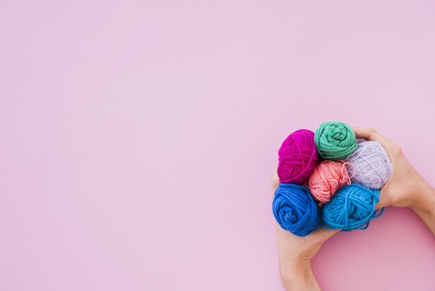 elevated view hand holding colorful wool pink background 2 High quality beautiful photo concept