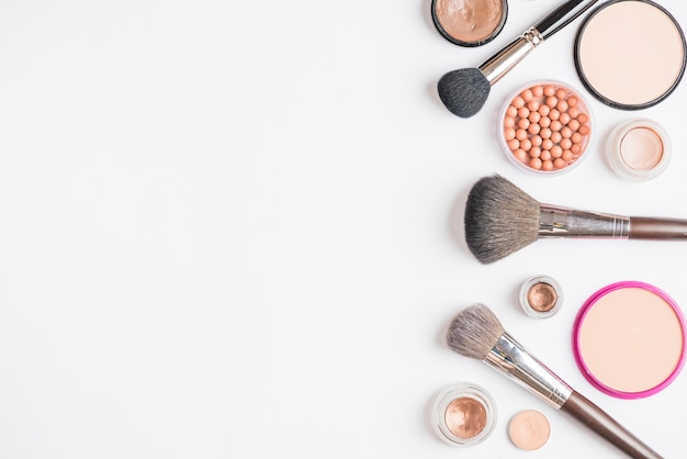 Elevated view of makeup products on white background